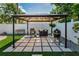 Outdoor kitchen area with barbecue grills, a gazebo, and paved flooring, perfect for entertaining at 202 S Hesperides St, Tampa, FL 33609