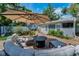 Charming outdoor living space featuring brick patio, comfortable seating, and fire pit under a large umbrella at 202 S Hesperides St, Tampa, FL 33609