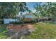 Side view of home featuring landscaped yard and fencing at 202 S Hesperides St, Tampa, FL 33609