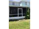 Shot of the back patio and green lawn of the building at 2213 Fluorshire Dr, Brandon, FL 33511