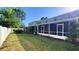 A view of the screened in back patio of the two story house with a green lawn at 2213 Fluorshire Dr, Brandon, FL 33511