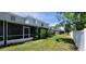 View of the townhome buildings featuring a backyard with lawn and screened-in patios at 2213 Fluorshire Dr, Brandon, FL 33511