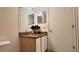 Bathroom featuring a vanity with a granite countertop, mirror, and storage cabinet at 2213 Fluorshire Dr, Brandon, FL 33511