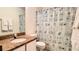 Functional bathroom with granite vanity, modern fixtures, and a shower curtain, providing a clean and practical space at 2213 Fluorshire Dr, Brandon, FL 33511