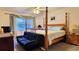 Cozy bedroom with a four-poster bed, ceiling fan, and natural light from the window at 2213 Fluorshire Dr, Brandon, FL 33511