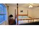 Bright bedroom with a four-poster bed, soft lighting, and modern decor at 2213 Fluorshire Dr, Brandon, FL 33511