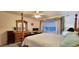 Comfortable bedroom with a wood four-poster bed and soft, natural light at 2213 Fluorshire Dr, Brandon, FL 33511