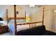 Well-lit bedroom with a four-poster bed, a ceiling fan, and ample natural light at 2213 Fluorshire Dr, Brandon, FL 33511