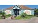 Exterior view of the community clubhouse with decorative design and landscaping at 2213 Fluorshire Dr, Brandon, FL 33511