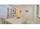 Elegant dining room with white furniture, decorative china cabinet, and neutral tones at 2213 Fluorshire Dr, Brandon, FL 33511