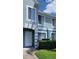Close up of light blue two-story townhome featuring a well-manicured lawn at 2213 Fluorshire Dr, Brandon, FL 33511