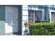 Inviting front door of a well-maintained home featuring a charming flower basket and manicured greenery at 2213 Fluorshire Dr, Brandon, FL 33511