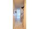 Hallway with tile floors leading to bright white vertical blinds in background at 2213 Fluorshire Dr, Brandon, FL 33511