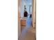 Hallway view leading to a bedroom, showcasing carpeted floors and neutral wall paint at 2213 Fluorshire Dr, Brandon, FL 33511