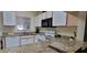 Spacious kitchen with granite countertops, classic white cabinetry, and modern appliances for a stylish cooking experience at 2213 Fluorshire Dr, Brandon, FL 33511