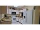 Functional kitchen with granite countertops, white appliances, and cabinets at 2213 Fluorshire Dr, Brandon, FL 33511