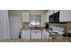 Kitchen with granite counters and modern appliances, with a view of the patio at 2213 Fluorshire Dr, Brandon, FL 33511