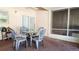 Cozy screened patio featuring brick flooring, seating area and a storage cabinet at 2213 Fluorshire Dr, Brandon, FL 33511