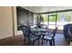Screened in patio with brick flooring, a table, four chairs and a lovely view of the backyard at 2213 Fluorshire Dr, Brandon, FL 33511