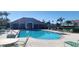 Community pool with lounge chairs and landscaped surroundings by the community center at 2213 Fluorshire Dr, Brandon, FL 33511