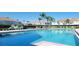Community pool surrounded by lounge chairs and lush landscaping at 2213 Fluorshire Dr, Brandon, FL 33511