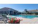 Community pool with lounge chairs and landscaped surroundings by the community center at 2213 Fluorshire Dr, Brandon, FL 33511