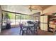 Sunroom with brick flooring, screened windows, table with chairs, and a ceiling fan at 2213 Fluorshire Dr, Brandon, FL 33511