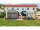Fenced backyard with patio and view of the home with a red roof from the grass lawn at 2700 Bayshore Blvd # 522, Dunedin, FL 34698