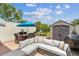 Outdoor patio with comfortable seating, blue umbrella, grill and shed at 2700 Bayshore Blvd # 522, Dunedin, FL 34698