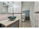 Bathroom features a modern vanity with a unique vessel sink and a view into the calming bedroom at 2700 Bayshore Blvd # 522, Dunedin, FL 34698
