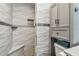 Bathroom featuring a shower with elegant tilework, a built-in seat, and stylish storage solutions at 2700 Bayshore Blvd # 522, Dunedin, FL 34698