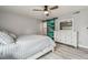 Bedroom features a ceiling fan, sliding distressed barn door, and sleek wood-look flooring at 2700 Bayshore Blvd # 522, Dunedin, FL 34698