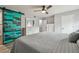 Bedroom featuring ceiling fan, sliding barn door, with dresser and wood-look flooring at 2700 Bayshore Blvd # 522, Dunedin, FL 34698