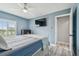 Bedroom featuring blue walls, a ceiling fan, and a shuttered window for natural light at 2700 Bayshore Blvd # 522, Dunedin, FL 34698