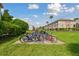 Community bike rack station with several bikes secured to the rack and lush green landscaping surrounding at 2700 Bayshore Blvd # 522, Dunedin, FL 34698