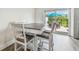 Dining area with modern table and chairs, adjacent to sliding glass doors and outdoor seating at 2700 Bayshore Blvd # 522, Dunedin, FL 34698