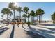Beautiful waterfront view on a sunny day at the community dock and marina with a walking path and palm trees at 2700 Bayshore Blvd # 522, Dunedin, FL 34698