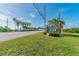 Welcoming entrance to Dunedin Causeway with lush green lawns, palm trees, and blue skies at 2700 Bayshore Blvd # 522, Dunedin, FL 34698