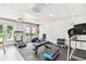 Community gym area featuring a treadmill, exercise bench, free weights, and rubber floor mats at 2700 Bayshore Blvd # 522, Dunedin, FL 34698