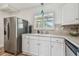 Bright kitchen with white cabinetry, stainless steel refrigerator, and natural light at 2700 Bayshore Blvd # 522, Dunedin, FL 34698