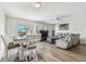 Open-concept living room with luxury vinyl flooring, comfortable seating, and sliding glass doors to the patio at 2700 Bayshore Blvd # 522, Dunedin, FL 34698