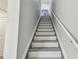 Bright stairwell leading up, featuring gray and white steps, with modern handrail at 2700 Bayshore Blvd # 522, Dunedin, FL 34698