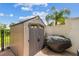 Durable outdoor storage shed in backyard with a patio and covered grill for functional outdoor living at 2700 Bayshore Blvd # 522, Dunedin, FL 34698