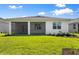 This home features a covered patio that overlooks a well-maintained lawn and backyard at 29156 Coral Harbour Dr, Englewood, FL 34223