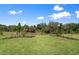 A lush backyard with a well-manicured lawn and beautiful landscaping offers a serene outdoor space at 29156 Coral Harbour Dr, Englewood, FL 34223