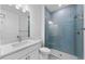 Modern bathroom featuring a blue tiled shower and a white vanity with sink at 29156 Coral Harbour Dr, Englewood, FL 34223