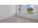 Bright bedroom featuring tile floors, white trim, and an outside view from the windows at 29156 Coral Harbour Dr, Englewood, FL 34223