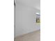 A neutral bedroom featuring light tile floors, white walls, and a window with a view at 29156 Coral Harbour Dr, Englewood, FL 34223