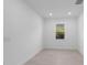 Bright bedroom with neutral tile flooring, white trim, and a single window offering natural light at 29156 Coral Harbour Dr, Englewood, FL 34223