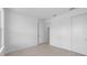 A bedroom featuring light tile floors, neutral walls, and access to a walk-in closet at 29156 Coral Harbour Dr, Englewood, FL 34223